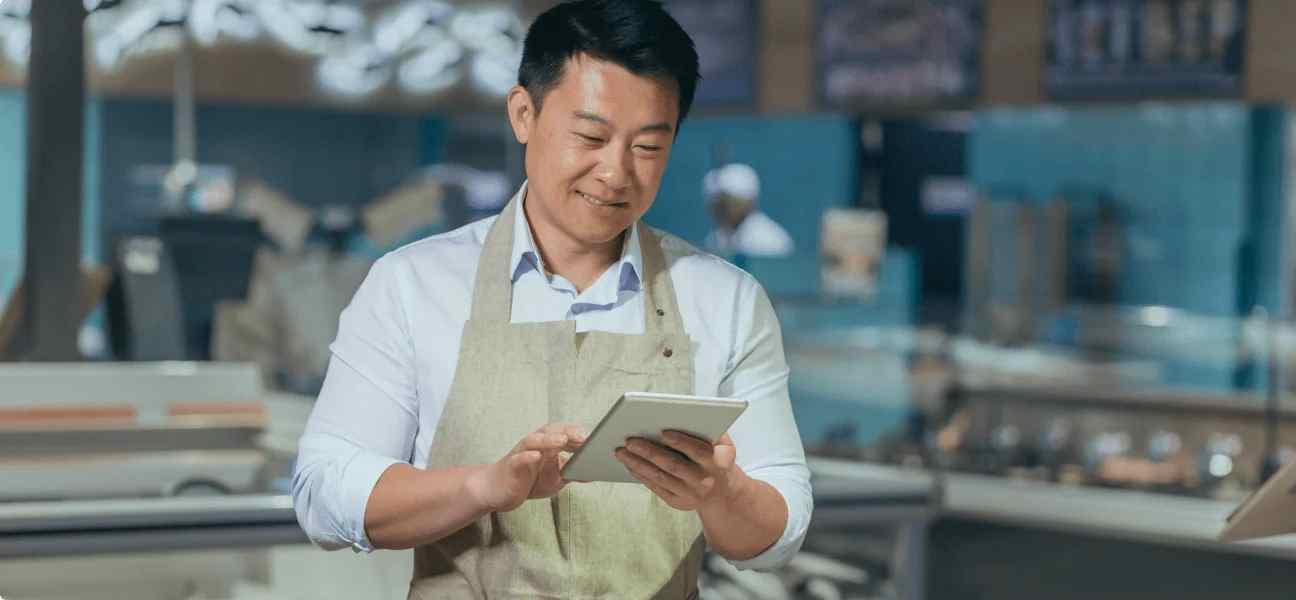 A chef checks temperature of refrigerator on their tablet and monitor humidity