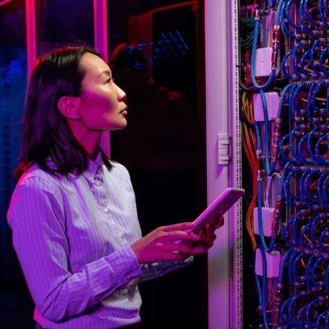 A female worker check electric wiring connectivity and note issue on tablet and analyse it