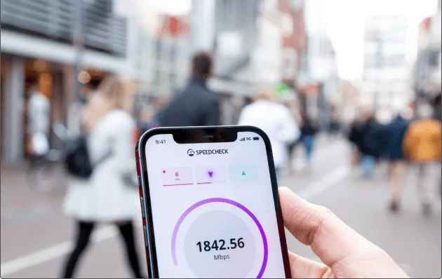 a application dashboard opens in a phone and person hold the phone with right hand in crowd area